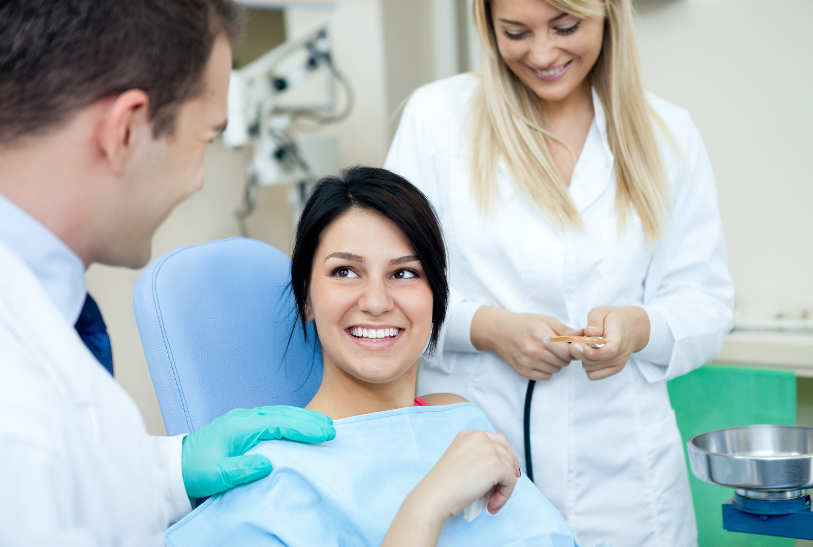 teen girl in dental chair smiling at dentist and assistant, Crittenden, KY family dentistry